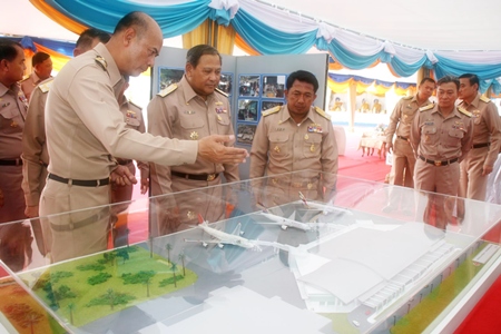 Navy Commander in Chief Adm. Kamthorn Pumhiran (center) and high ranking officers inspect a model of the new facilities at U-Tapao Pattaya International Airport.